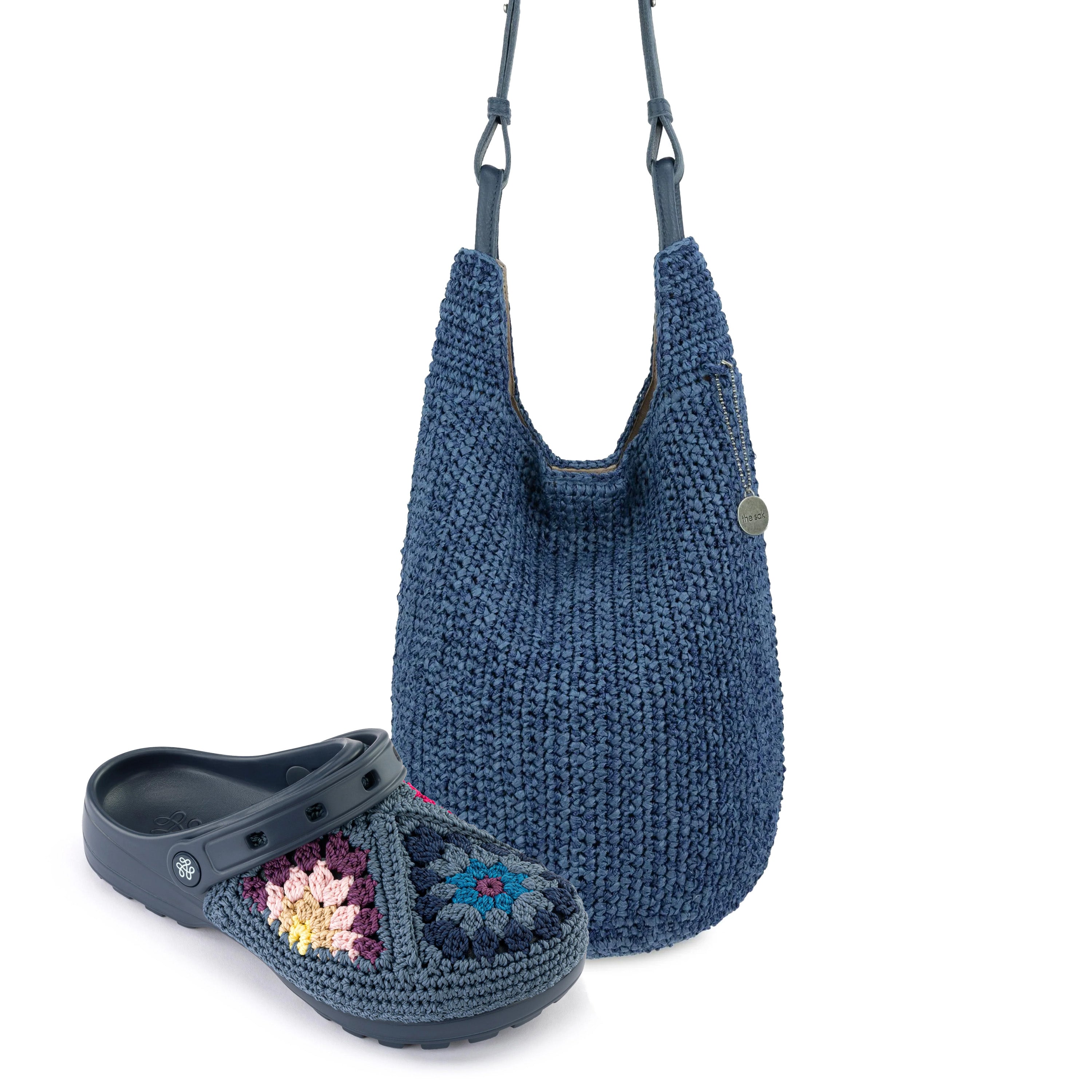 Blue knit hobo bag with shoulder straps and matching crocheted clog with embroidered floral design.