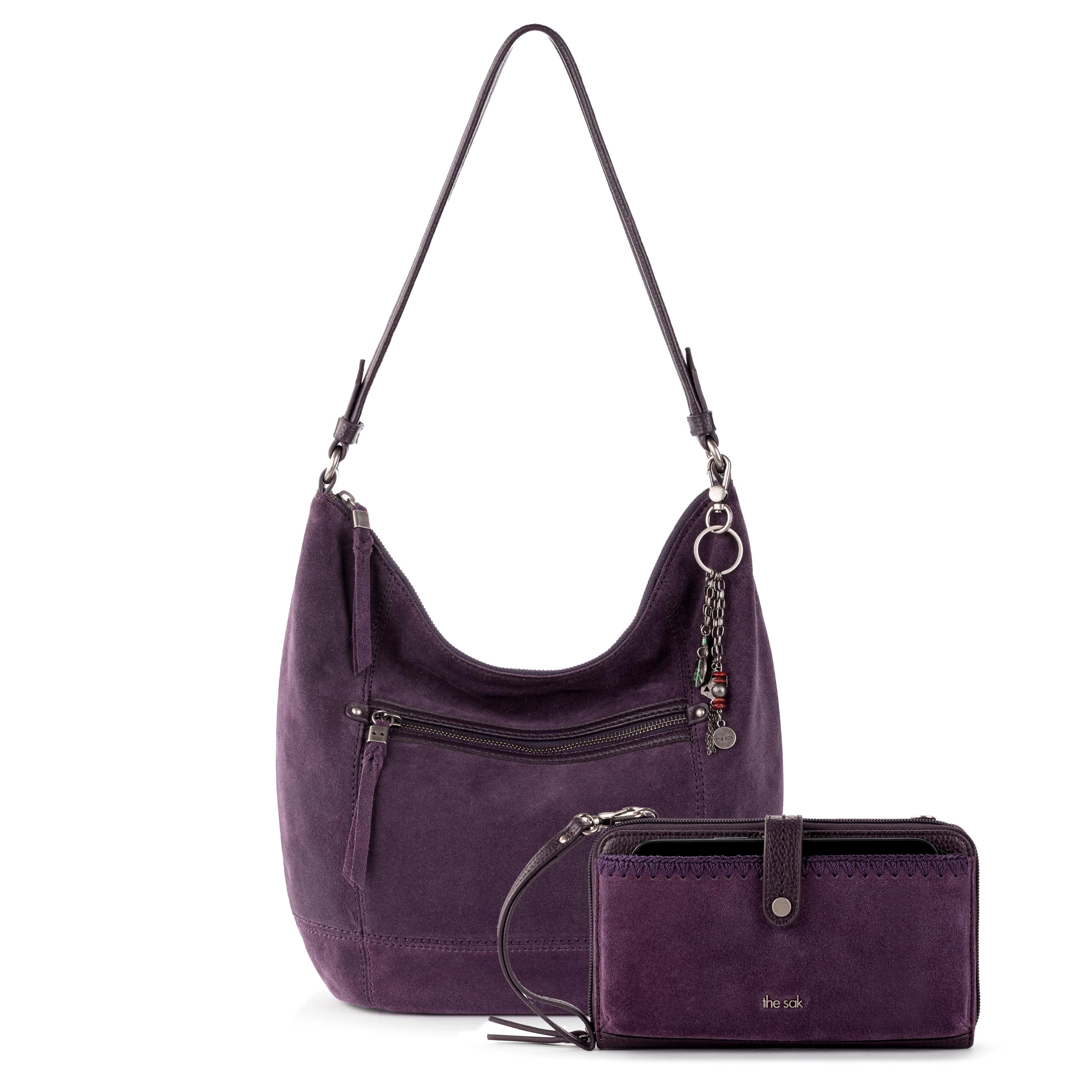 Purple leather hobo bag with shoulder strap and matching purple wallet with wrist strap and metal hardware.
